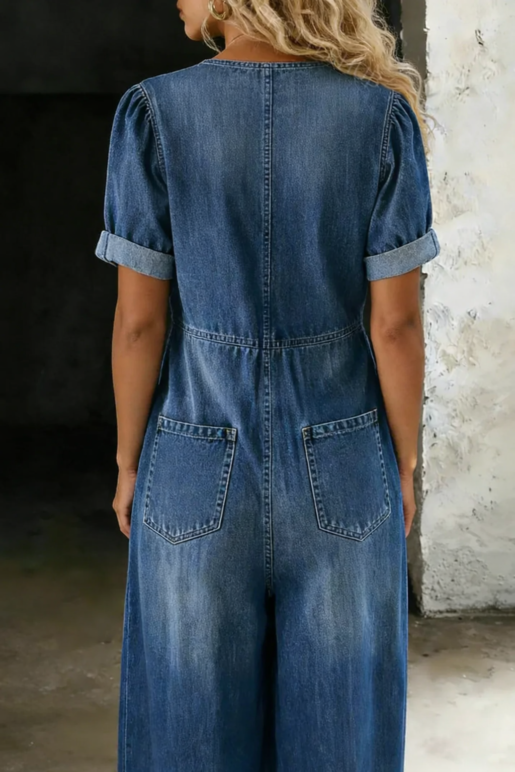 Bennett and Family Maya denim wide-leg jumpsuit with adjustable straps and relaxed fit, shown from front view.