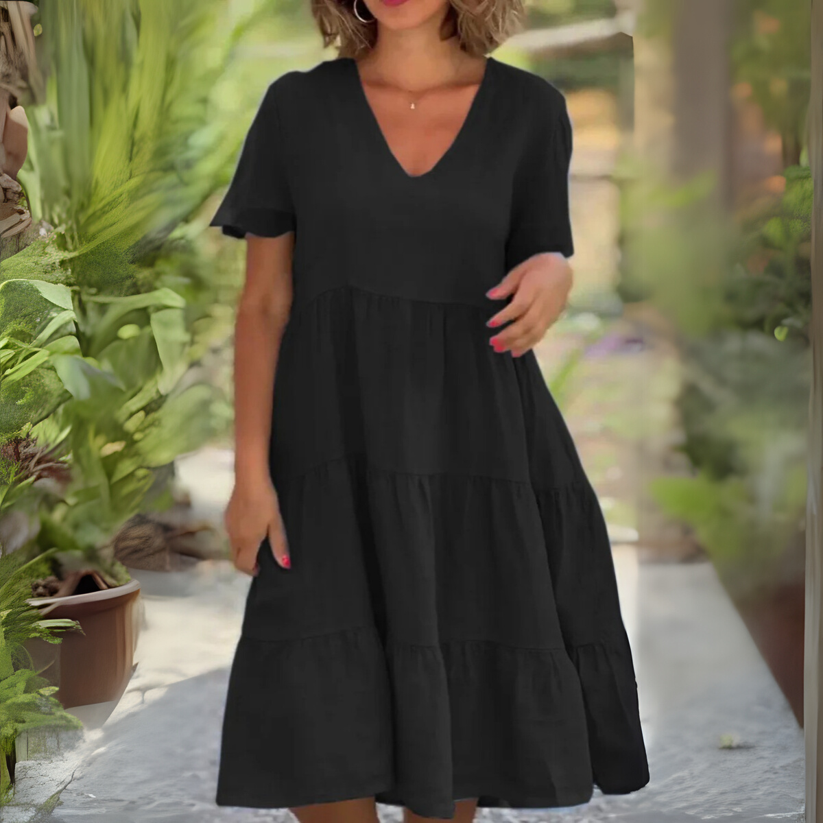 Black loose dress with V-neck from The Rowan Daughters' Luce collection, showcasing flowing fabric and relaxed fit.