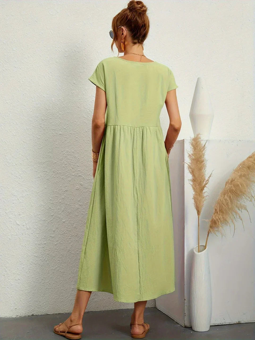 Flowing midi dress by Bennett and Family featuring a relaxed fit and elegant design, ideal for casual or semi-formal wear.