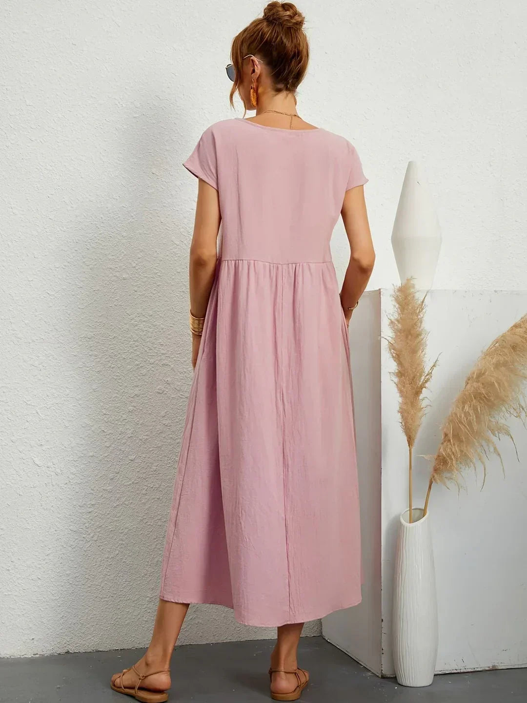Flowing midi dress in soft fabric with a relaxed fit, featuring a feminine silhouette and elegant design by Bennett and Family.