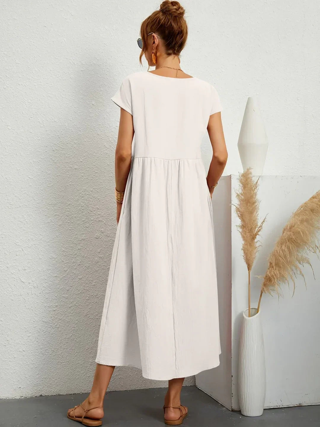 Light blue Gabrielle Flowing Midi Dress by Bennett And Family, featuring a flowing fabric and elegant silhouette.