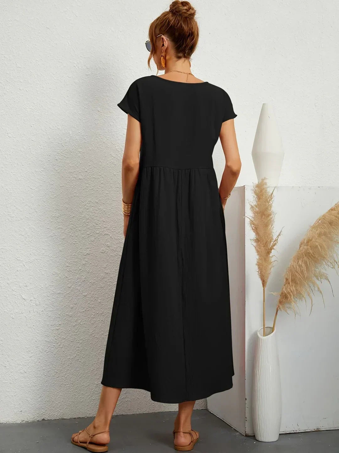 Flowing Gabrielle midi dress by Bennett and Family, featuring a lightweight fabric and elegant design, displayed on a hanger.