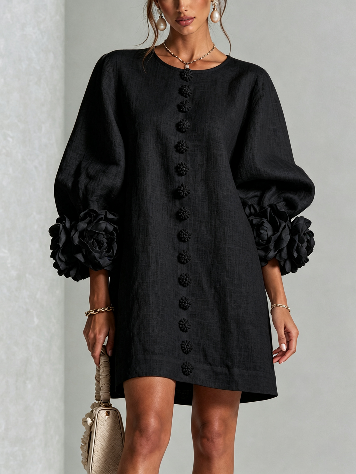 Black Susanna Mini Dress by Bennett And Family, shown on a hanger with detailed fabric texture and stylish design elements.