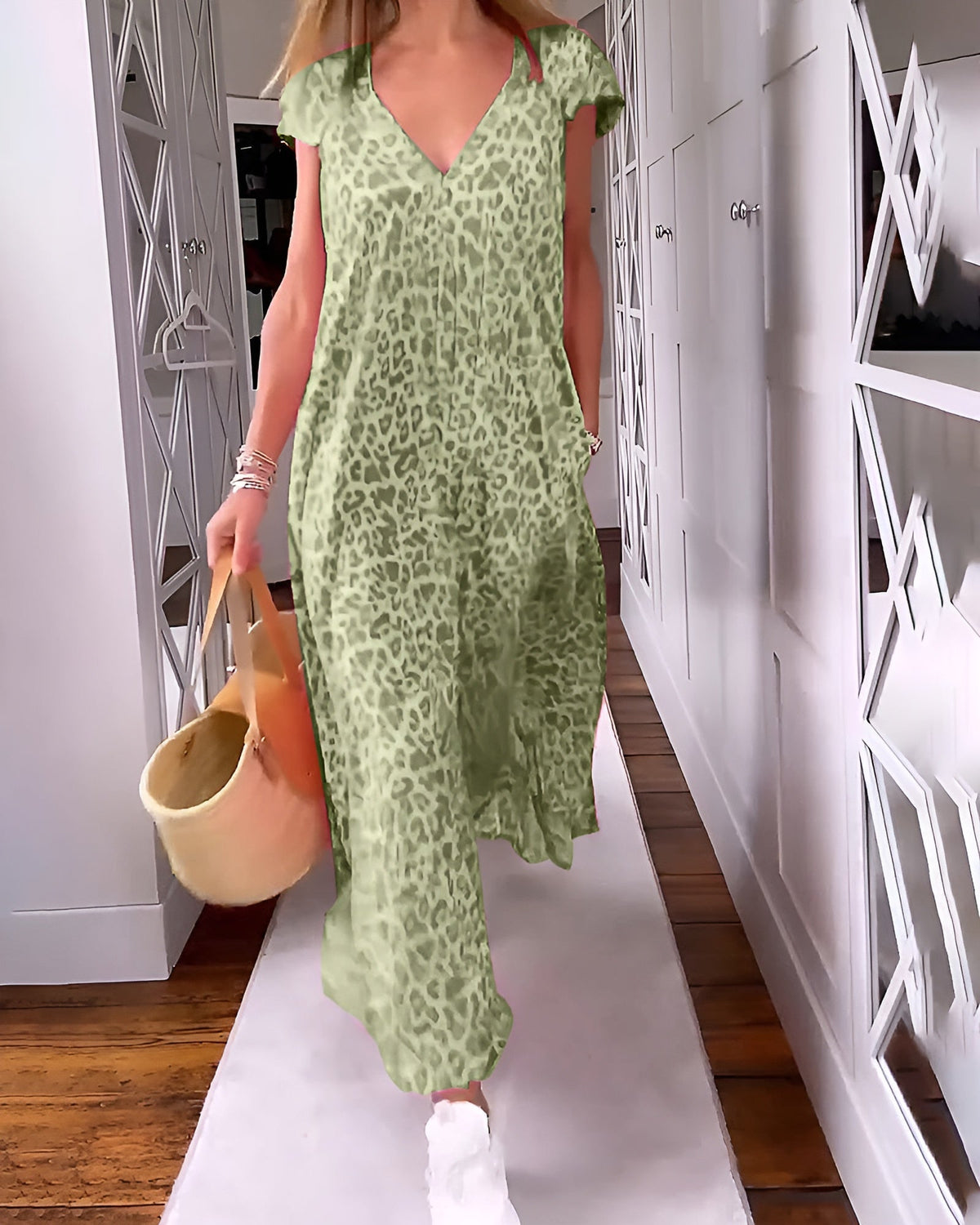 Véronique long dress by The Rowan Daughters featuring a V-neckline and short sleeves, shown in a flowing fabric.
