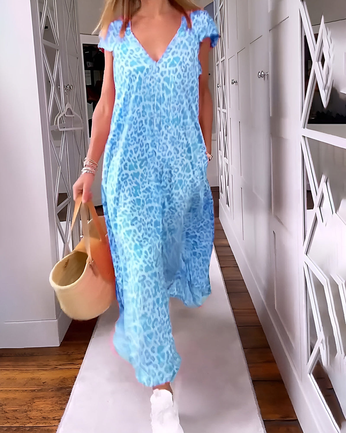 Véronique long dress by The Rowan Daughters featuring a V-neckline, short sleeves, and flowing fabric in a stylish silhouette.