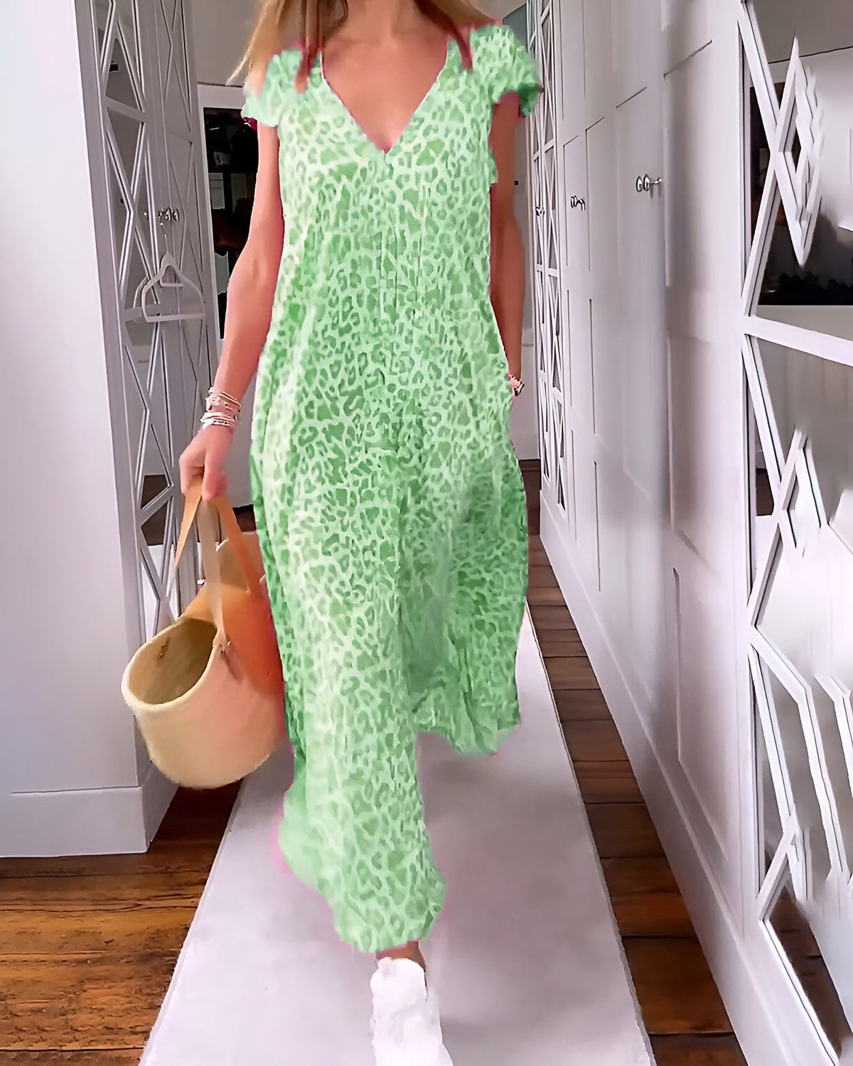 Véronique long dress with V-neck and short sleeves by The Rowan Daughters, shown in a flowing fabric on a model.