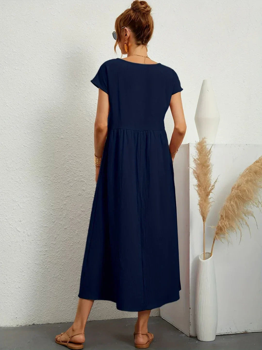 Flowing Gabrielle Midi Dress by Bennett And Family displayed on a model, featuring lightweight fabric and elegant design.