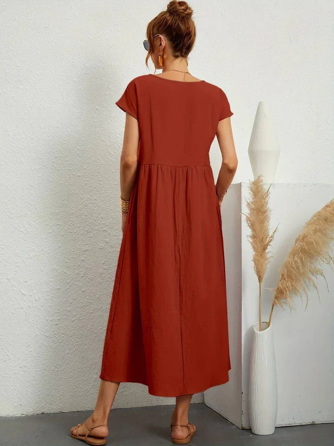 Flowing midi dress by Bennett and Family featuring a relaxed fit and elegant silhouette, perfect for casual or semi-formal wear.