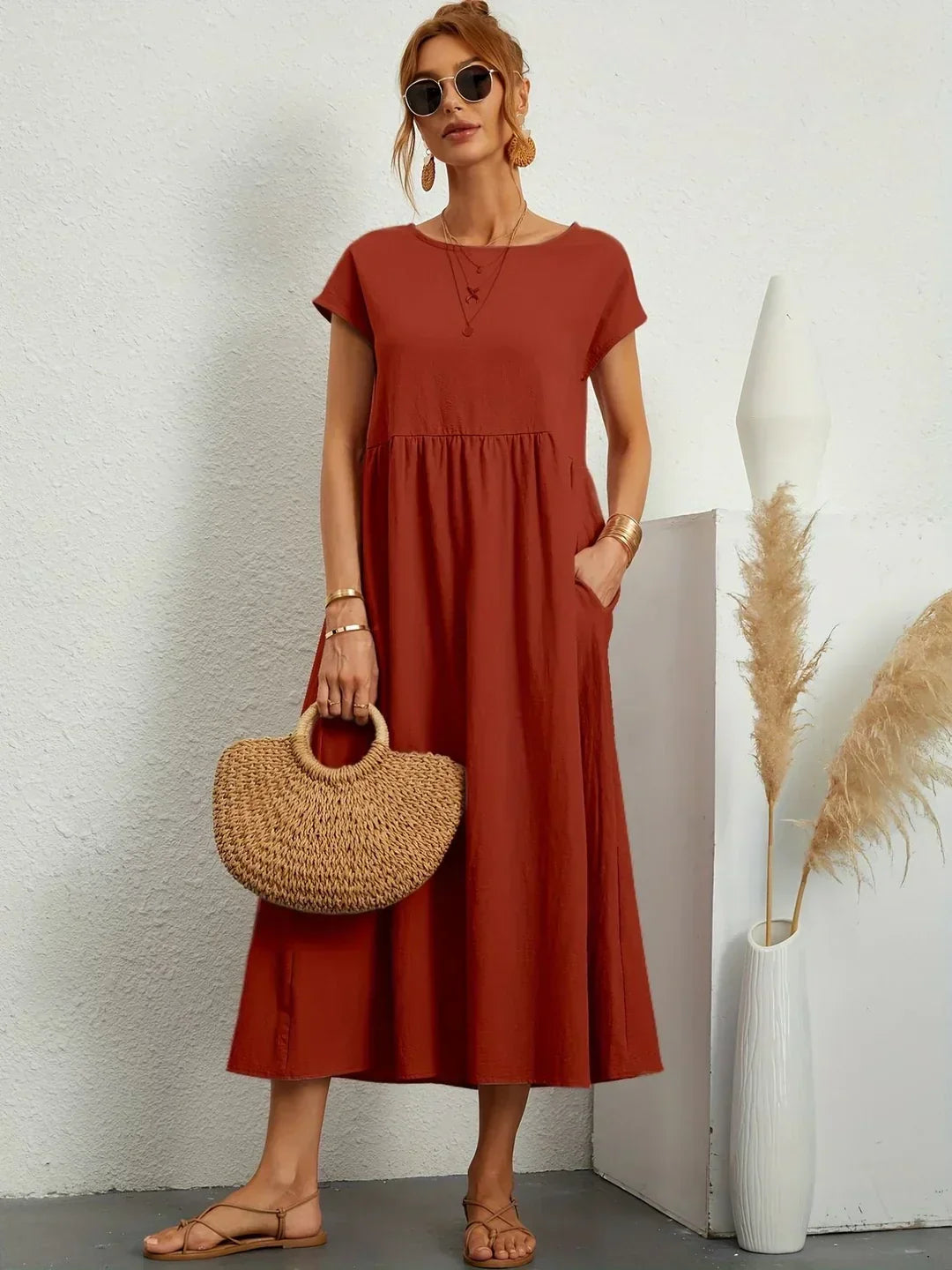 Flowing midi dress by Bennett and Family, featuring a relaxed fit and elegant design, shown in a natural fabric with a graceful drape.