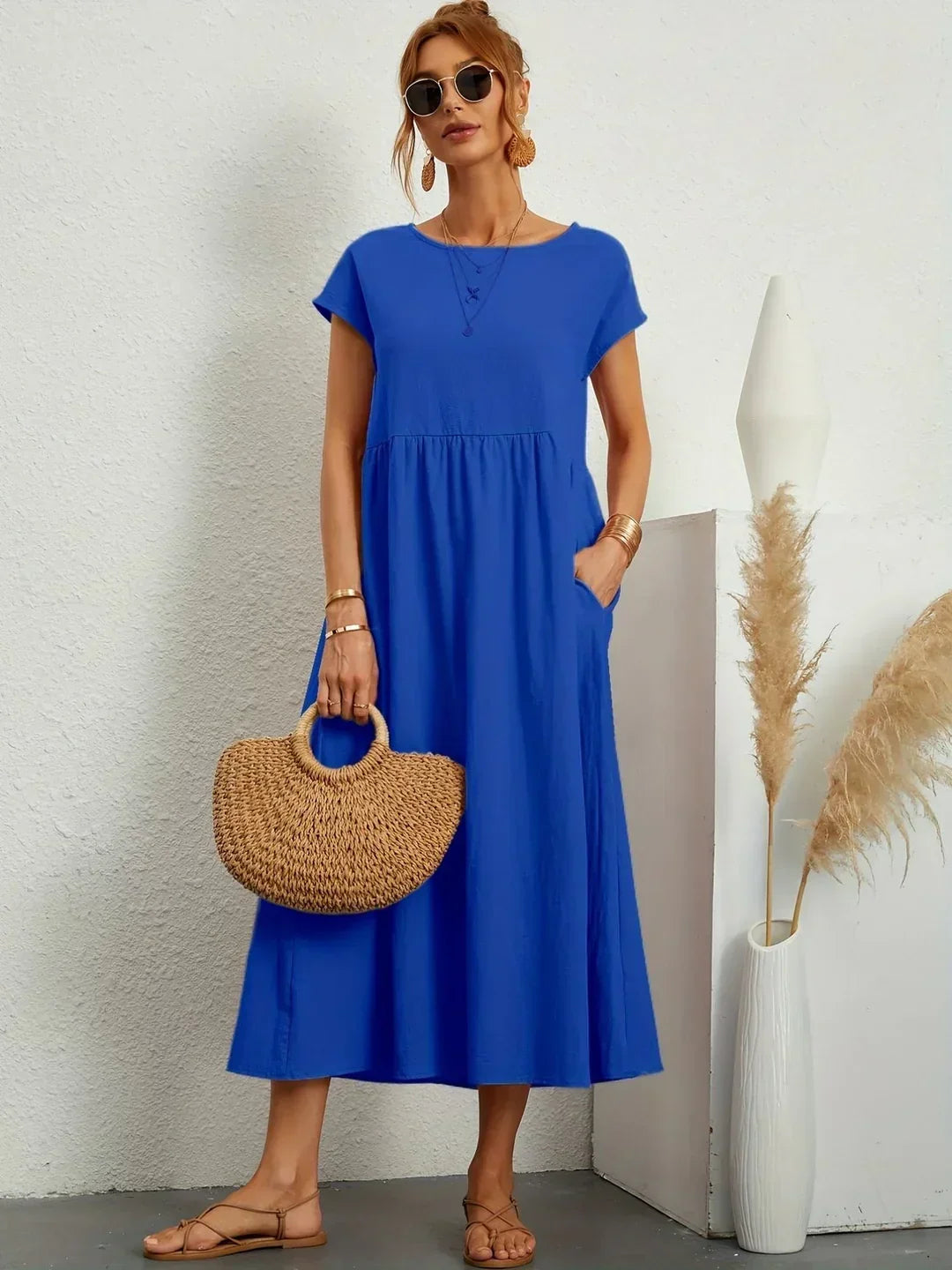 Light blue Gabrielle Flowing Midi Dress by Bennett And Family displayed on a model, showcasing its elegant, flowing fabric and midi length.