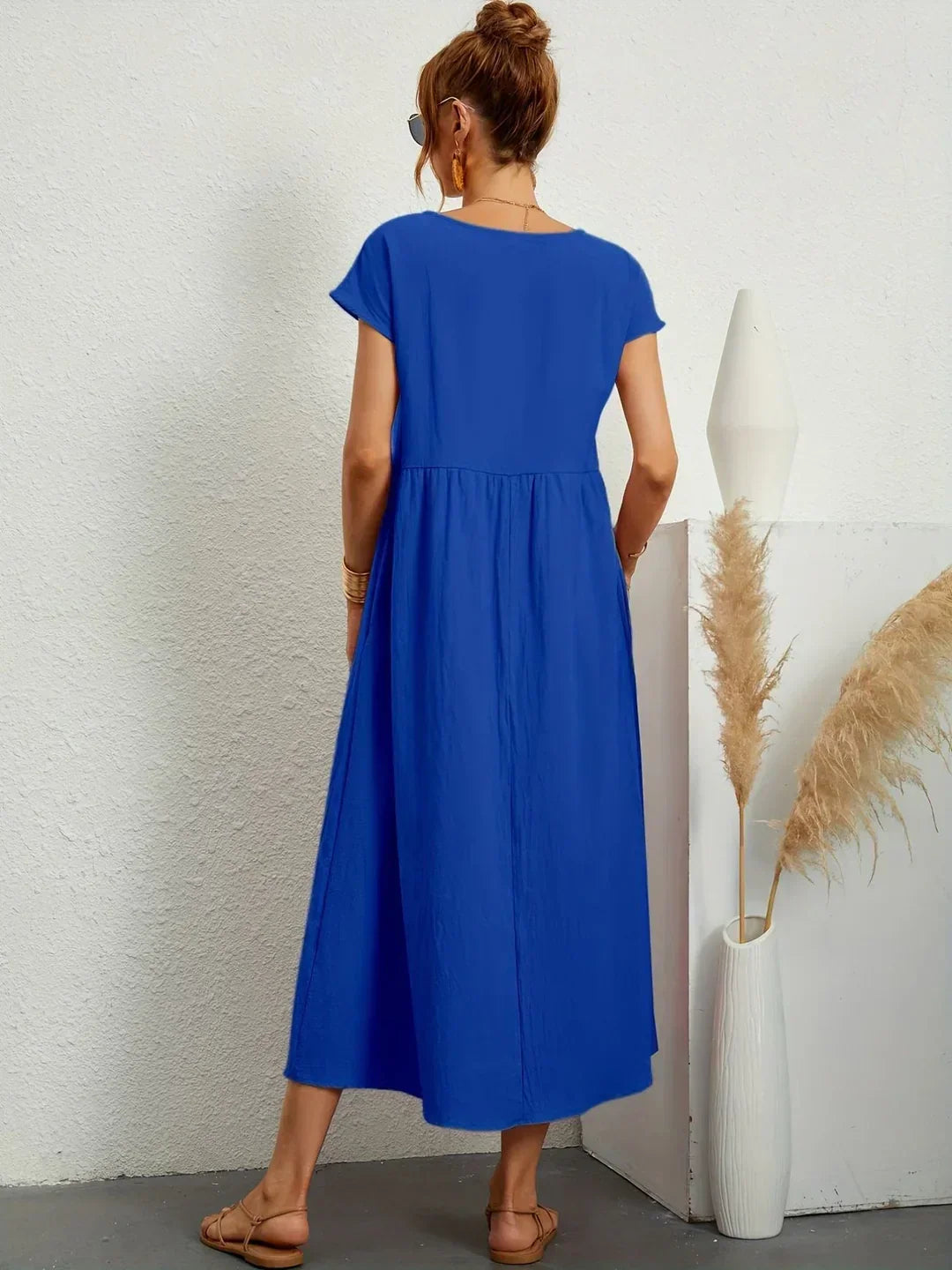 Flowing midi dress by Bennett and Family, featuring a loose fit, soft fabric, and elegant design, suitable for casual or formal wear.