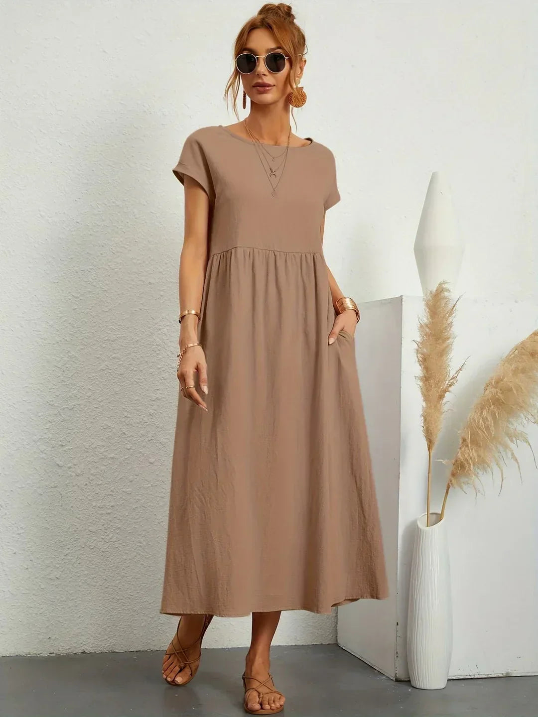 Light blue Gabrielle flowing midi dress by Bennett and Family, featuring a relaxed fit and elegant fabric, displayed on a hanger.