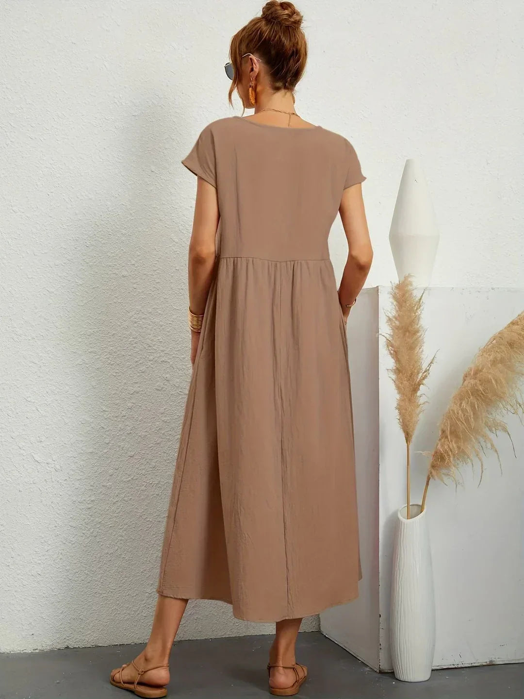 Flowing midi dress by Bennett and Family featuring a relaxed fit, soft fabric, and elegant design, perfect for stylish daytime wear.