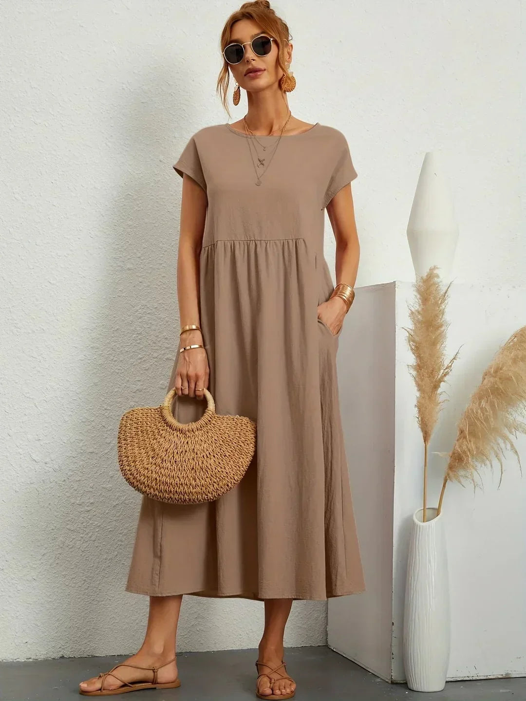 Flowing Gabrielle midi dress by Bennett and Family, featuring lightweight fabric and elegant design, displayed on a hanger.