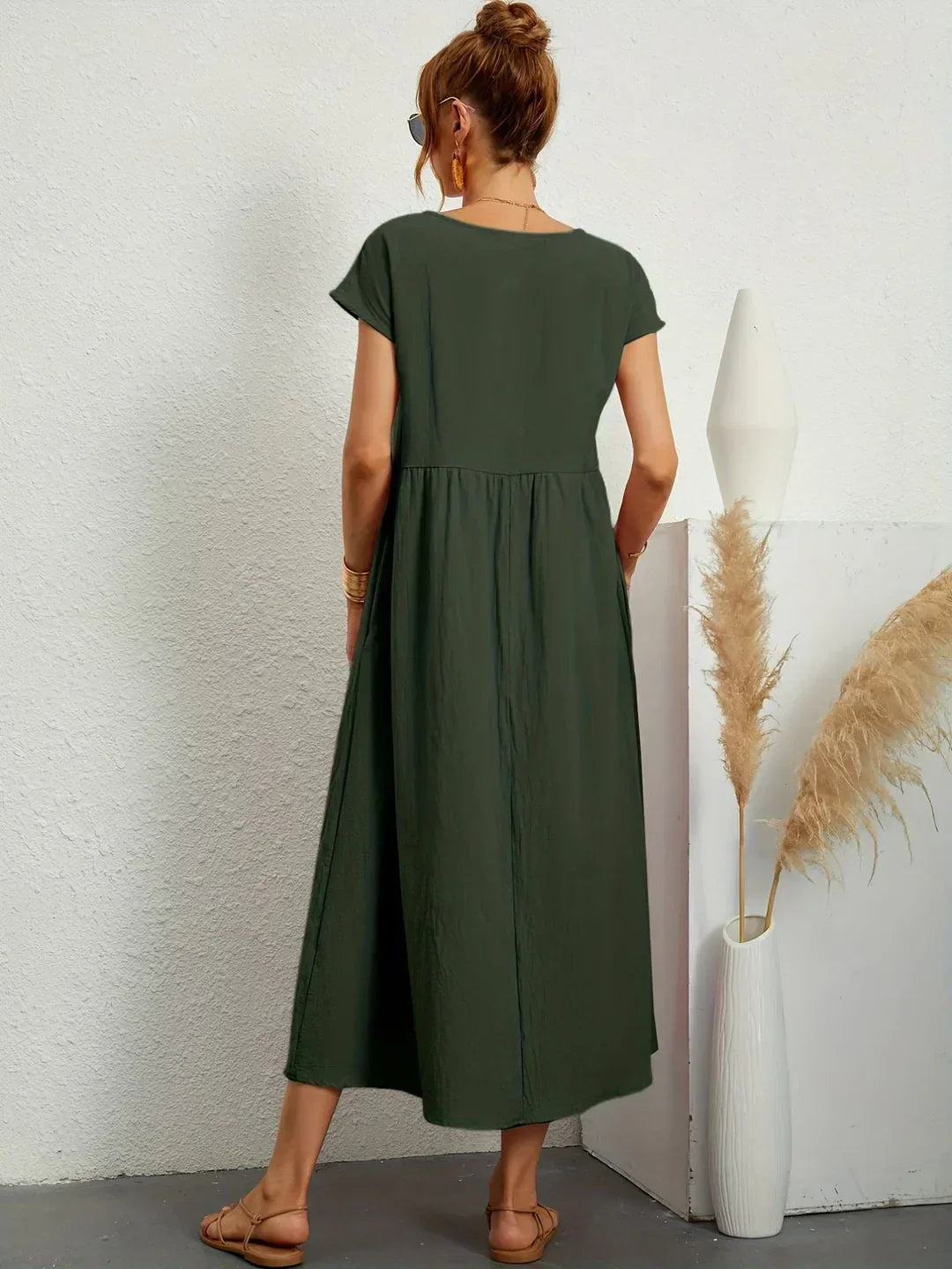 Flowing midi dress from Bennett and Family featuring a relaxed fit, lightweight fabric, and elegant design in soft, neutral tones.