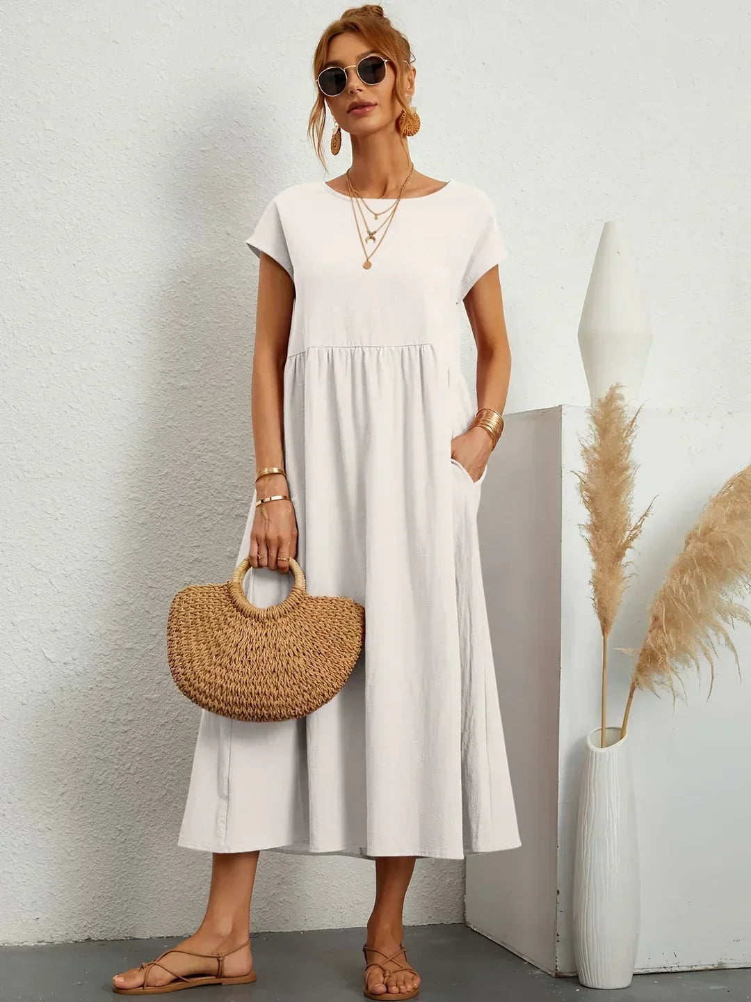 Light blue Gabrielle Flowing Midi Dress by Bennett and Family, featuring a flowing fabric and elegant design.