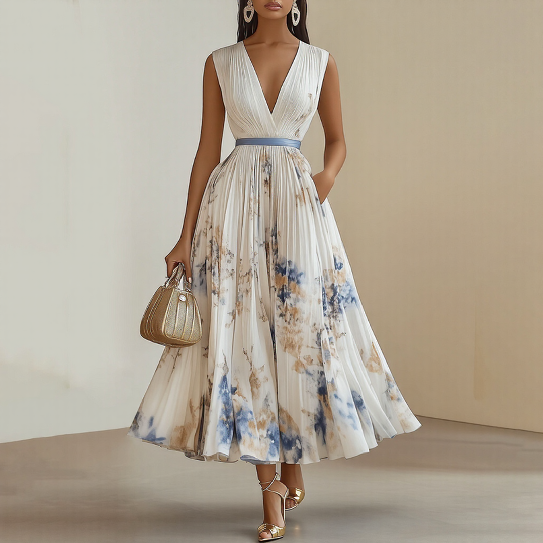 Elara dress by The Rowan Daughters featuring a soft V-neck and flowing fabric, worn by a model in a neutral-toned setting.