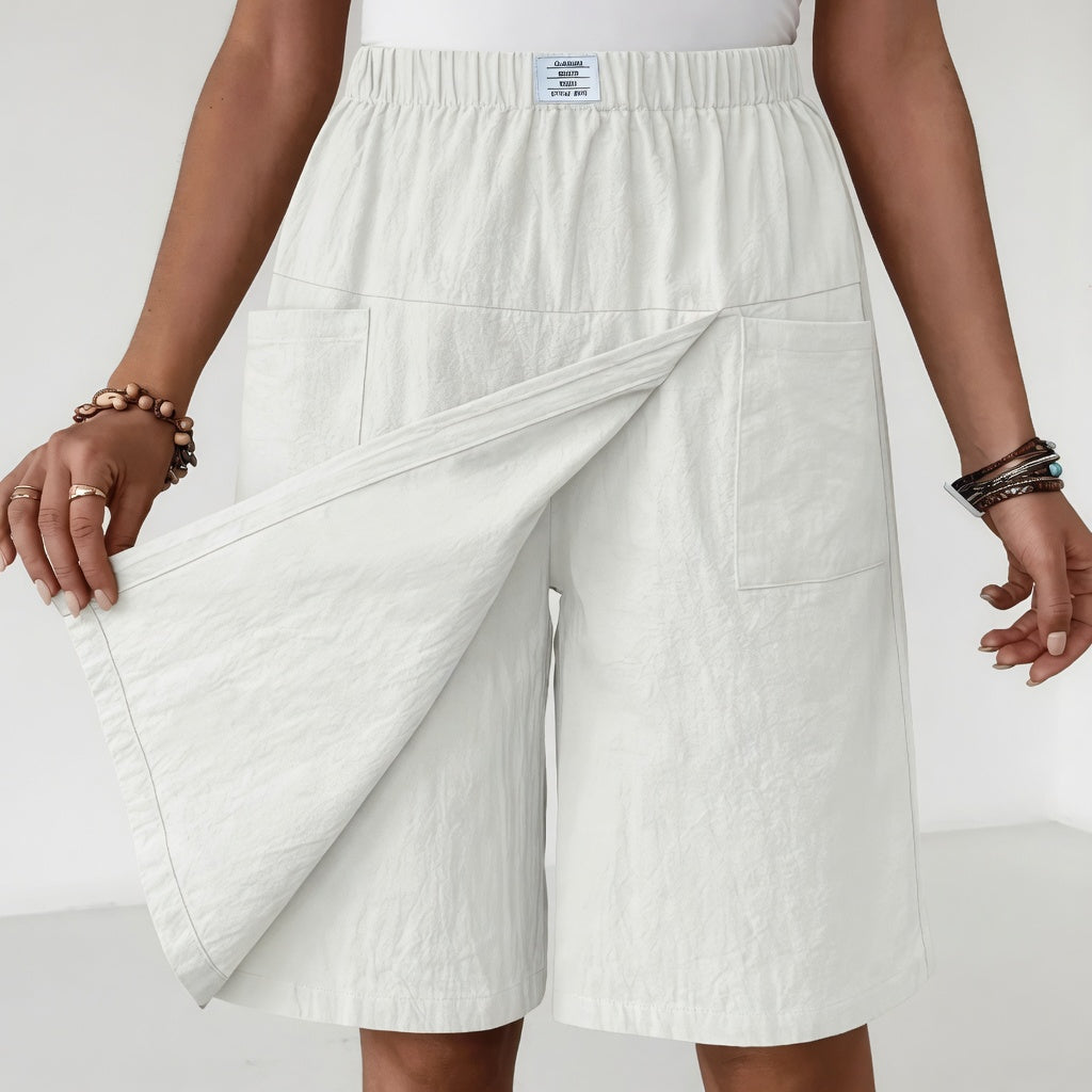 White Maeve wrap-front skort by Bennett and Family, showing a stylish women's skirt with a wrap detail and a clean, white fabric finish.