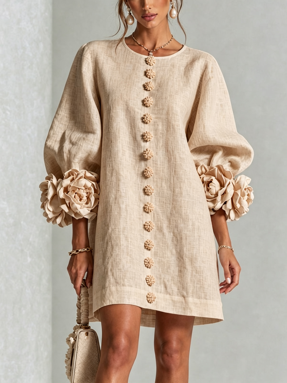 Beige Susanna Mini Dress by Bennett And Family, shown on a hanger with detailed fabric and simple design.